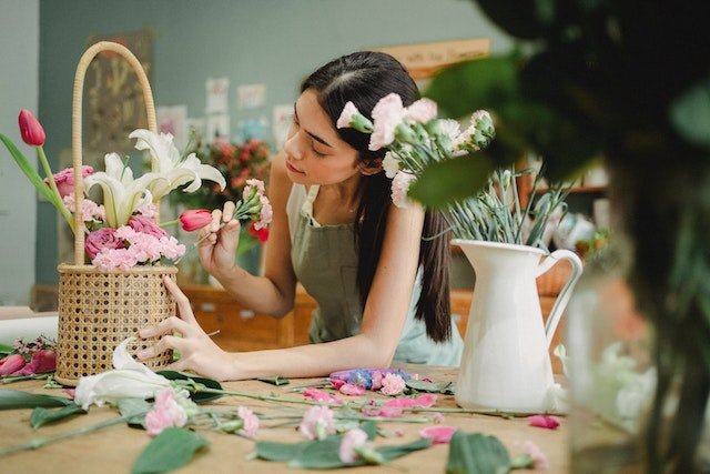 woman arranging flowers for a flower shop